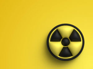 A 3D image of the radioactive symbol, highlighting radioactivity and signs of radiation exposure.
