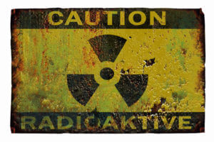 Rusty sign with the inscription caution, radiation.