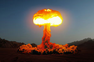 Terrible explosion of a nuclear bomb with a mushroom in the desert causing radiation exposure.